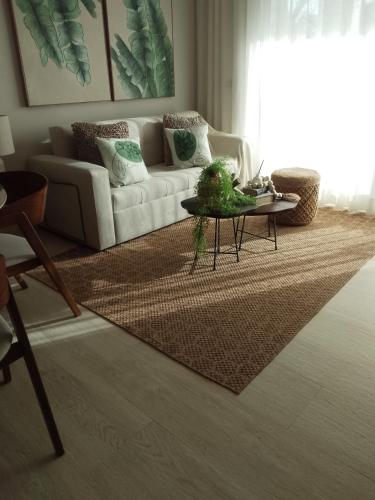 a living room with a couch and a table at Bora 102 Garden Breeze 1 in La Laguna