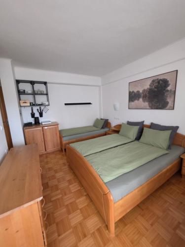 a bedroom with a large bed and a wooden floor at Cozy Nook Stays near Rogla & Terme Zreče in Zreče