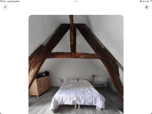 a bedroom with a bed in a attic at Le nid marin in Étretat
