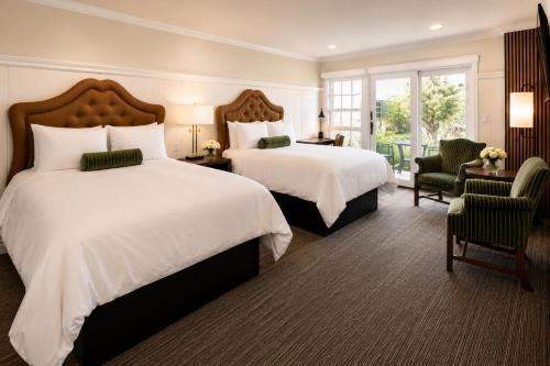 a hotel room with two beds and a window at Wayside Inn in Carmel