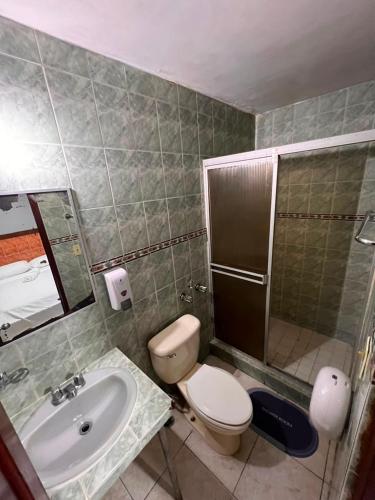 a bathroom with a toilet and a sink at Pension Calidonia in Panama City
