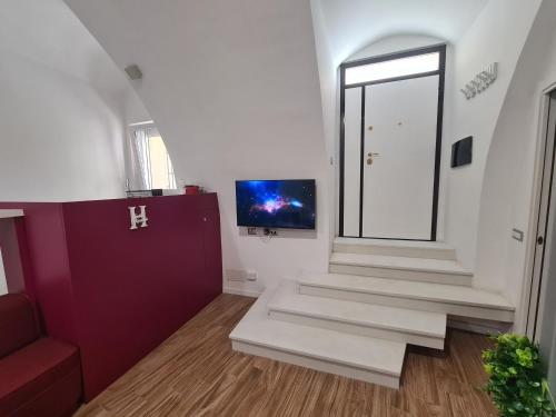 a room with stairs and a tv on the wall at Horizon Suite Bellavista in Catanzaro