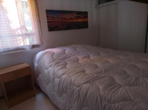 a white bed in a room with a window at Mazet du bonheur in Saint-Martin-de-Brômes