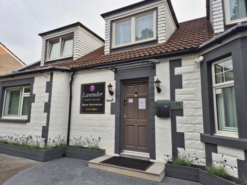 a house with a brown door on a street at Lavender Guest House, Near Royal Infirmary, Edinburgh in Edinburgh
