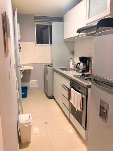 a small kitchen with a sink and a stove at Apto Amoblado Luxury in Bucaramanga