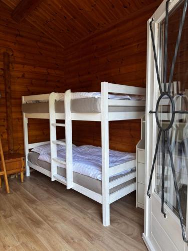 a bedroom with two bunk beds in a cabin at Seesen Private Lodge in Seesen