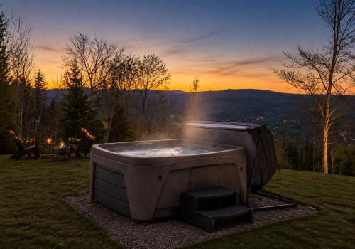 a hot tub in a field with a sunset in the background at Modern Comfort - Spa - Mountain - Chalet ALBA in Saint Come