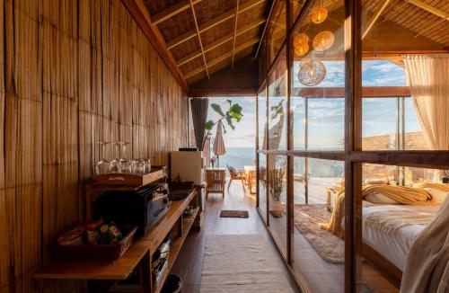 a bedroom with a bed and a view of the ocean at เลอดอย Le Doi in Ban Huai Khai