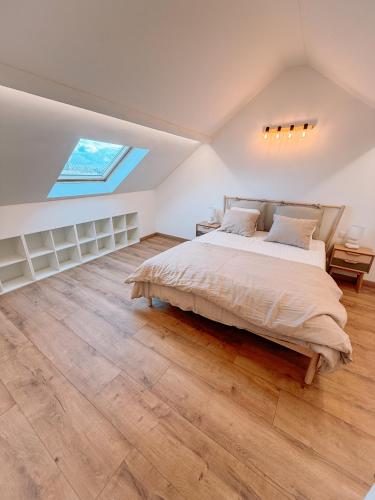 a bedroom with a large bed and a skylight at AirportHouse in Charleroi