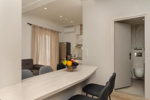 a kitchen and living room with a counter and chairs at Nimaria Suites in Gialova