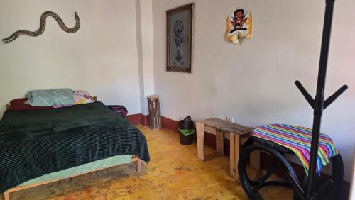 a bedroom with a bed and a table in it at Moon Garden House in Pisac