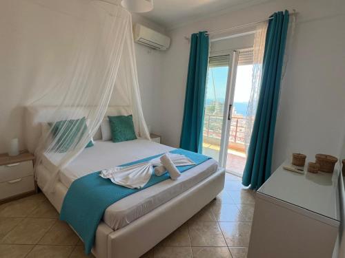 a bedroom with a bed with a mosquito net at Apartment Katherina Sarande in Sarandë
