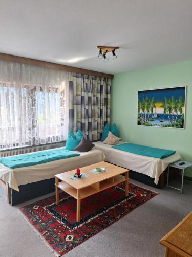 a hotel room with two beds and a table at Appartement Simone Hofherr in Imst