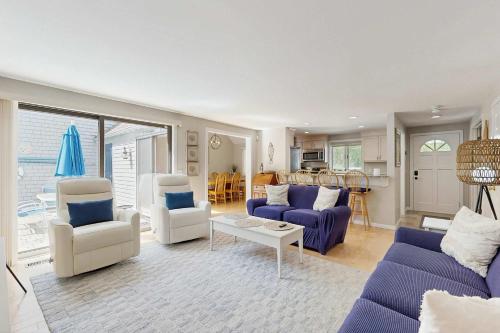 a large living room with blue couches and chairs at New Seabury Escape in Mashpee