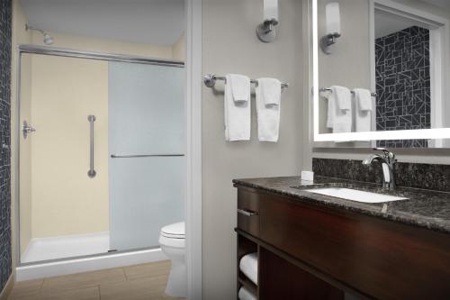 a bathroom with a toilet and a sink and a shower at Homewood Suites by Hilton Oklahoma City-Bricktown in Oklahoma City