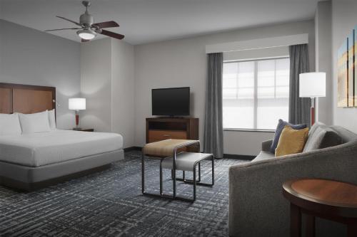 a hotel room with a bed and a couch at Homewood Suites by Hilton Oklahoma City-Bricktown in Oklahoma City