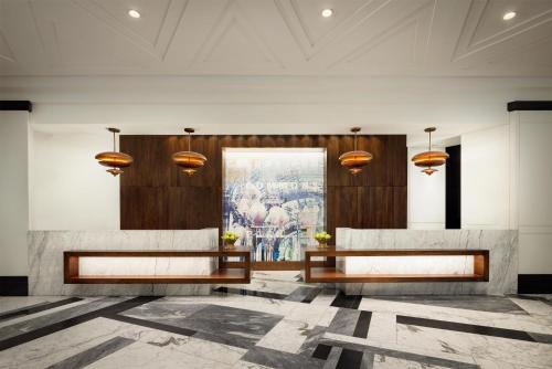 a lobby with two benches and a painting on the wall at Hilton Boston Back Bay in Boston
