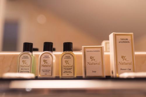 a row of four bottles of natural products on a shelf at The Llanelwedd Arms Hotel in Builth Wells