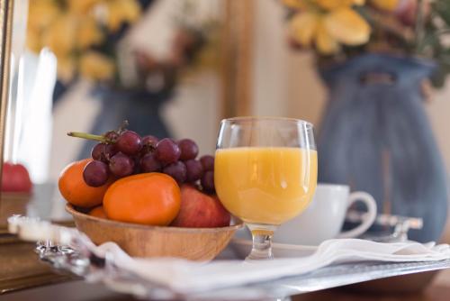 a bowl of fruit and a glass of orange juice at The Llanelwedd Arms Hotel in Builth Wells