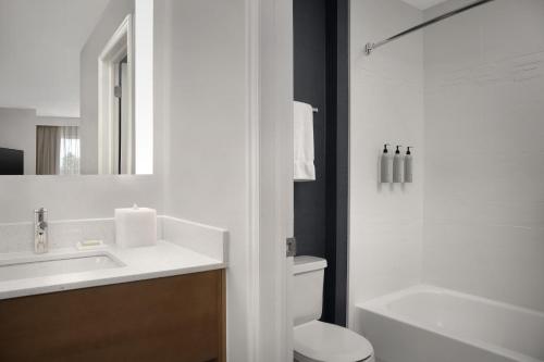 a bathroom with a sink and a toilet and a mirror at Residence Inn by Marriott Provo North University in Provo