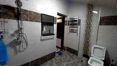 a bathroom with a shower and a sink and a toilet at Village in Oğuz