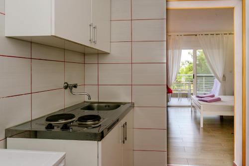 a kitchen with a sink and a stove at Wild Beauty in Sutomore