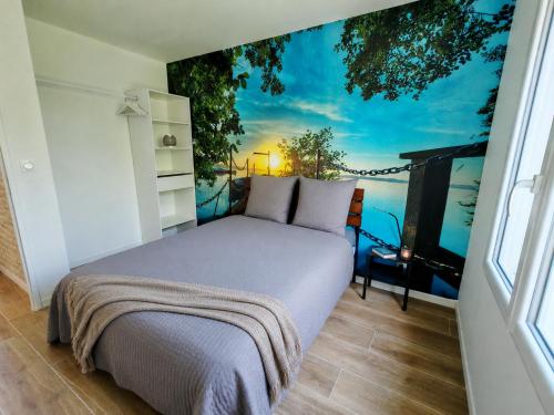 a bedroom with a bed with a view of the ocean at Le temps de la pause 1 in Cepoy