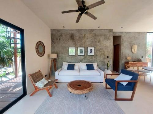 a bedroom with a bed and a living room at Design Luxury Villa in Holbox Island