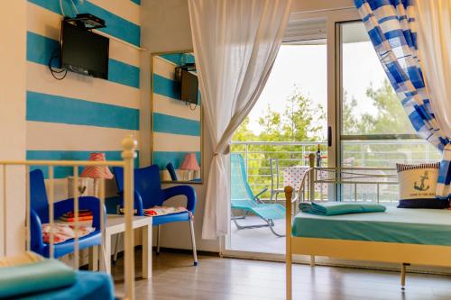 a bedroom with two beds and a balcony at Wild Beauty in Sutomore
