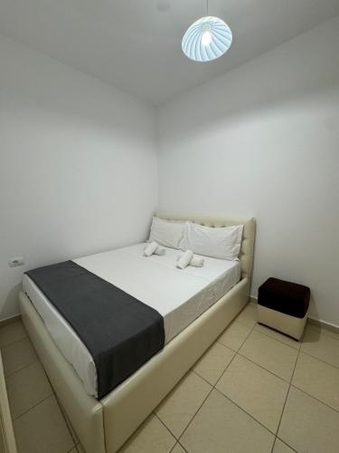 a bedroom with a bed in a white room at Hotel Luis in Durrës