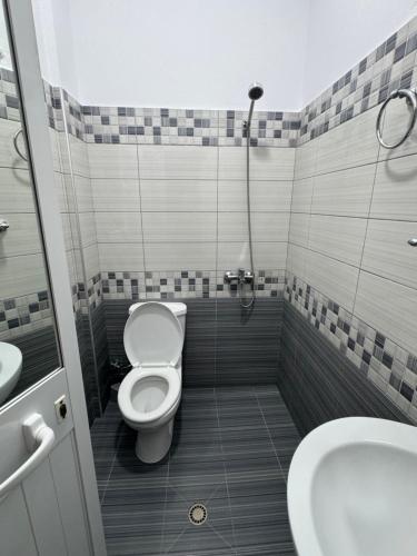 a bathroom with a toilet and a sink at Hotel Luis in Durrës
