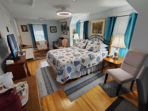 a bedroom with a bed and a chair at Digby Bed and Breakfast in Digby