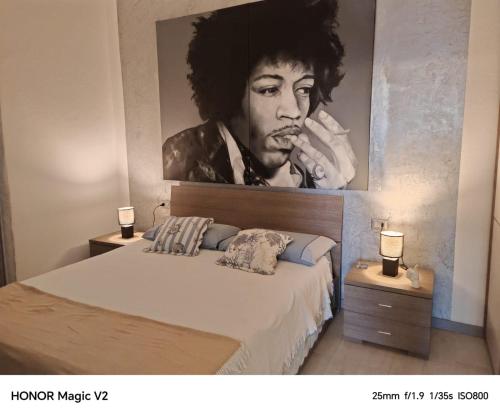 a bedroom with a large painting of a man with a cigar at Loft Pietrasanta in Pietrasanta