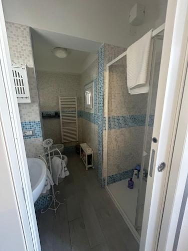 a bathroom with a shower and a sink and a tub at Loft Pietrasanta in Pietrasanta