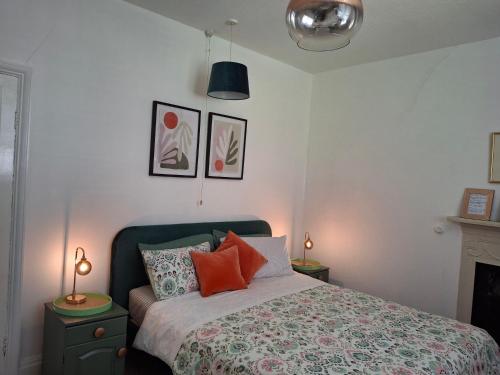 a bedroom with a bed and two lamps at JESMOND House B&B room 1 in Hull
