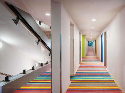 a hallway with a colorful rug on the floor at ibis Styles Budapest Citywest in Budapest