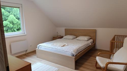 a bedroom with a bed and a window at Rekreačné domy pod Vlkolíncom in Ružomberok