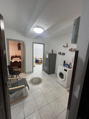 a living room with a bed and a washing machine at Apartament 33 in Elbasan