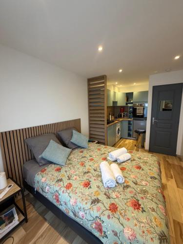 a bedroom with a bed with two towels on it at Studio in Cogolin