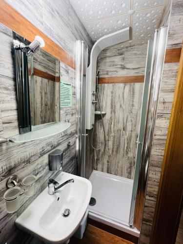 a bathroom with a sink and a shower at Da Lat Homestay - mit EisCafe in Bad Schandau