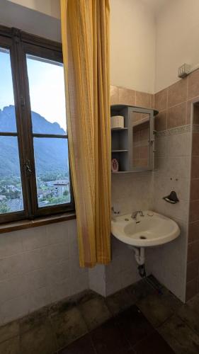 a bathroom with a sink and a window at Antica osteria in Primaluna