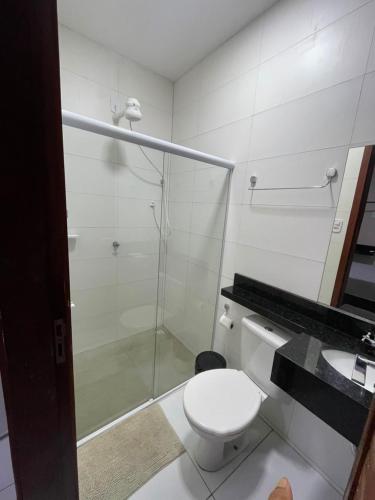 a bathroom with a shower and a toilet and a sink at Hotel maria araujo in Arapiraca