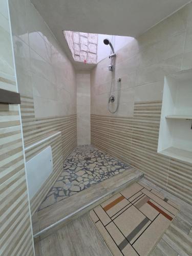 a bathroom with a shower and a bathtub with a shower at Puteoli Stop vacation home in Pozzuoli