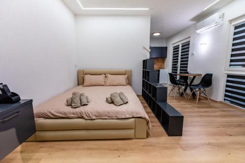 a bedroom with a bed and a table and chairs at IlieskiApartment in Prilep