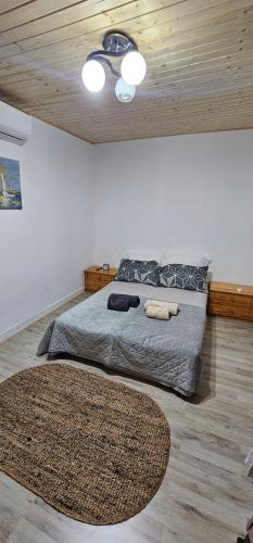 a bedroom with a large bed with a wooden ceiling at Cabana Relax in Râmnicu Vâlcea