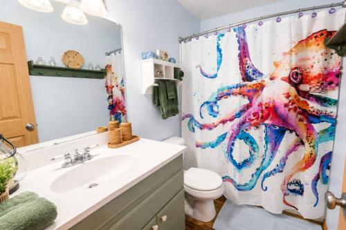 a bathroom with a shower curtain with an octopus on it at Beach Bungalow in Rockaway Beach