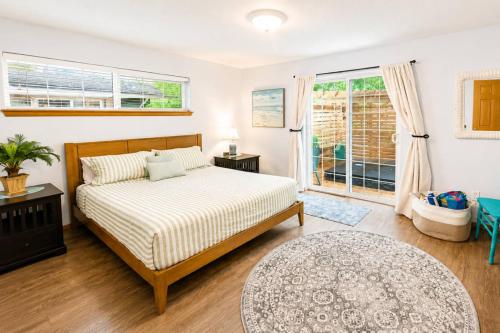 a bedroom with a bed and a window at Beach Bungalow in Rockaway Beach