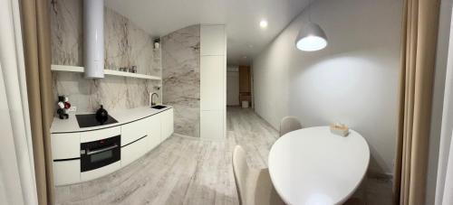a kitchen with white counters and a white counter top at Bila Perlyna - Люкс, пляж, паркінг, укриття in Odesa