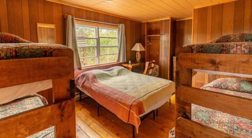a bedroom with two bunk beds and a window at Shadowcliff Mountain Lodge & Retreat Center in Grand Lake
