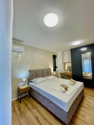 a bedroom with a large white bed in a room at Villa Ivana in Peroj